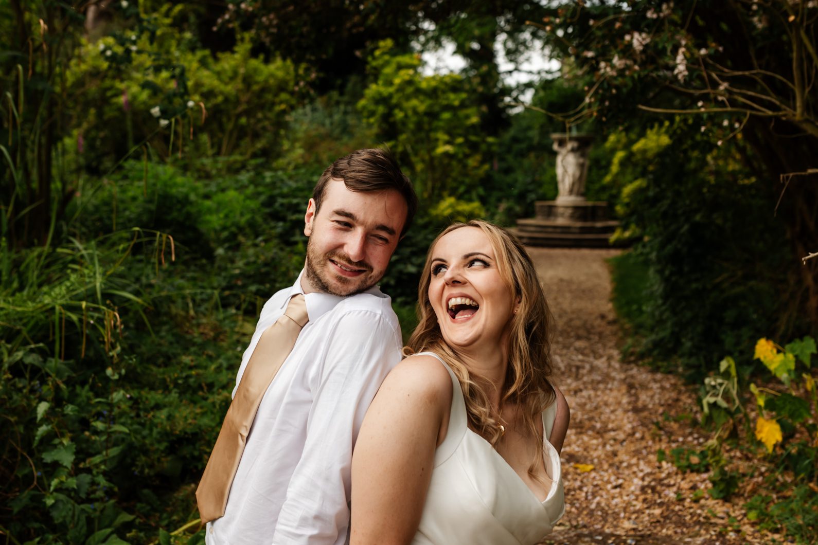 Bride and groom grinning and looking at each other