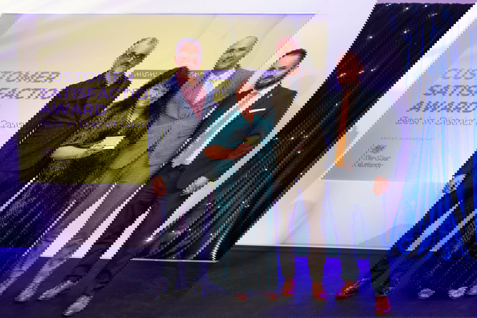 Group photo of award winners at corporate awards evening