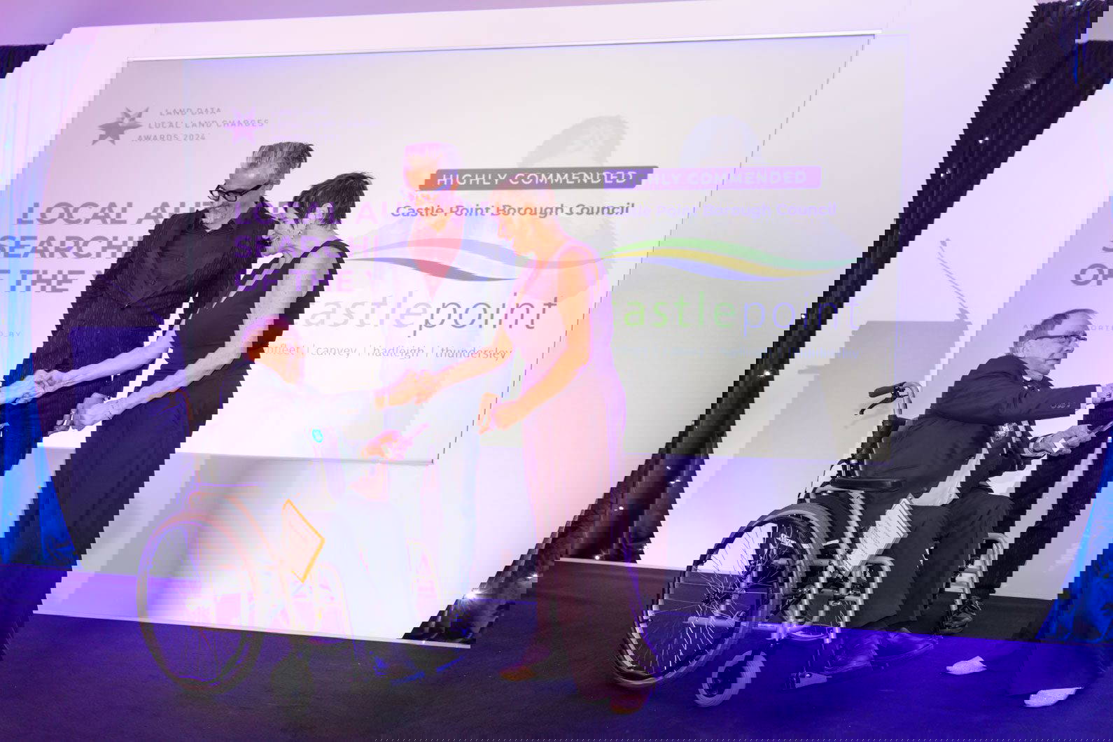 Awards ceremony host presenting trophy at Midlands event