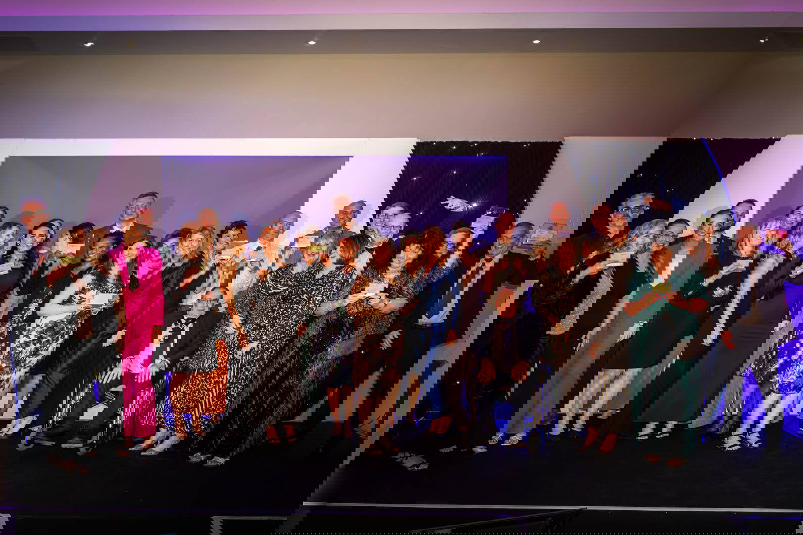 Group photo of all award winners at corporate awards evening