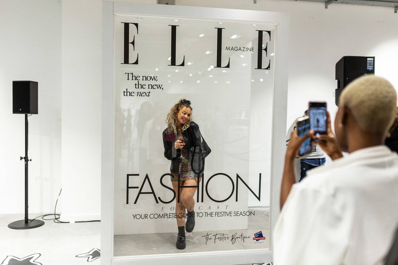 Corporate Activation Photography-26 Guests posing inside a life-size magazine installation at a fashion brand activation