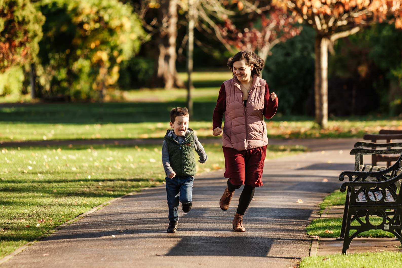Mum and son running together during a family photoshoot in Birmingham