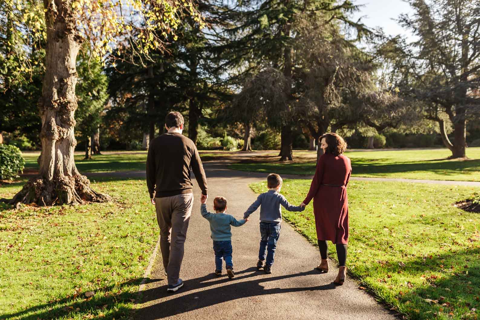 Family walking together away from the camera during a natural photoshoot in Birmingham