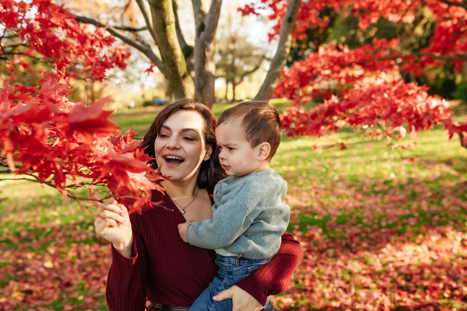 Mum and son enjoying autumn colours during a family photoshoot in Birmingham