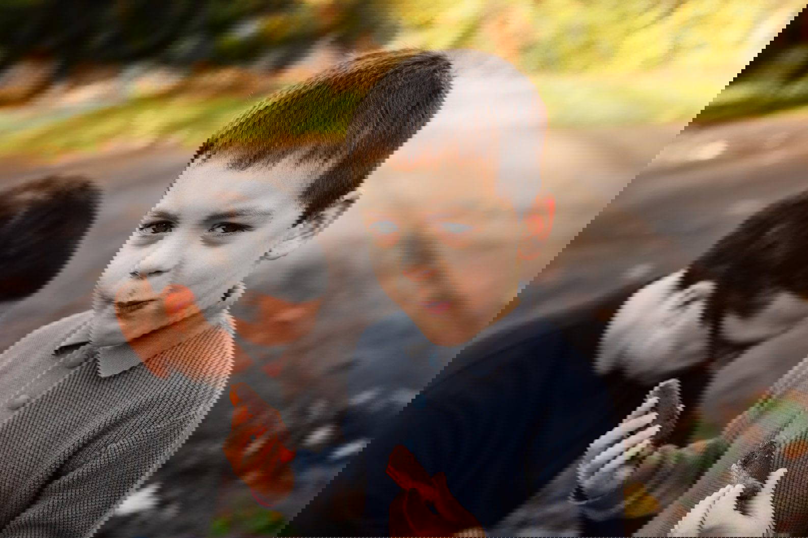 Young boy eating a snack during a casual family photoshoot in Birmingham