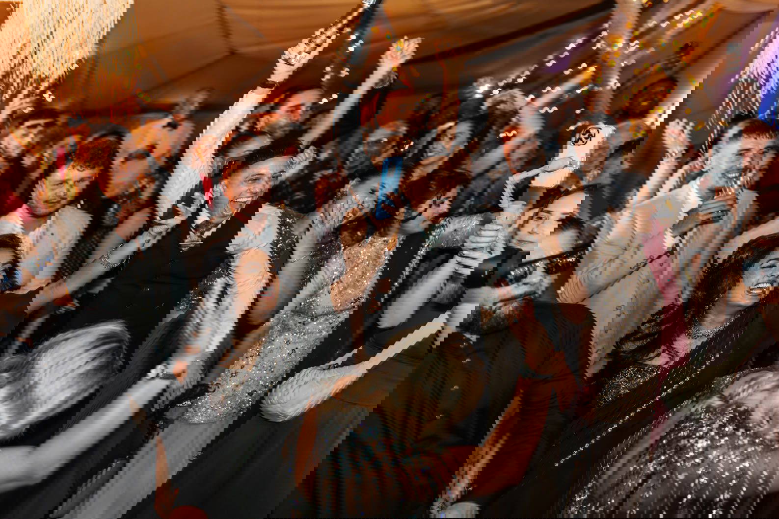 Energetic wedding dance floor photographs capturing friends dancing