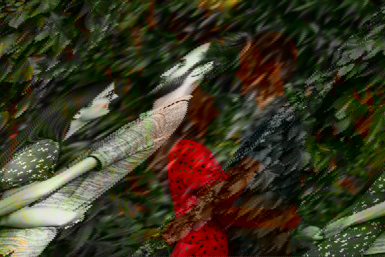Couple cuddling surrounded by leaves at the University of Birmingham West Midlands engagement shoot.