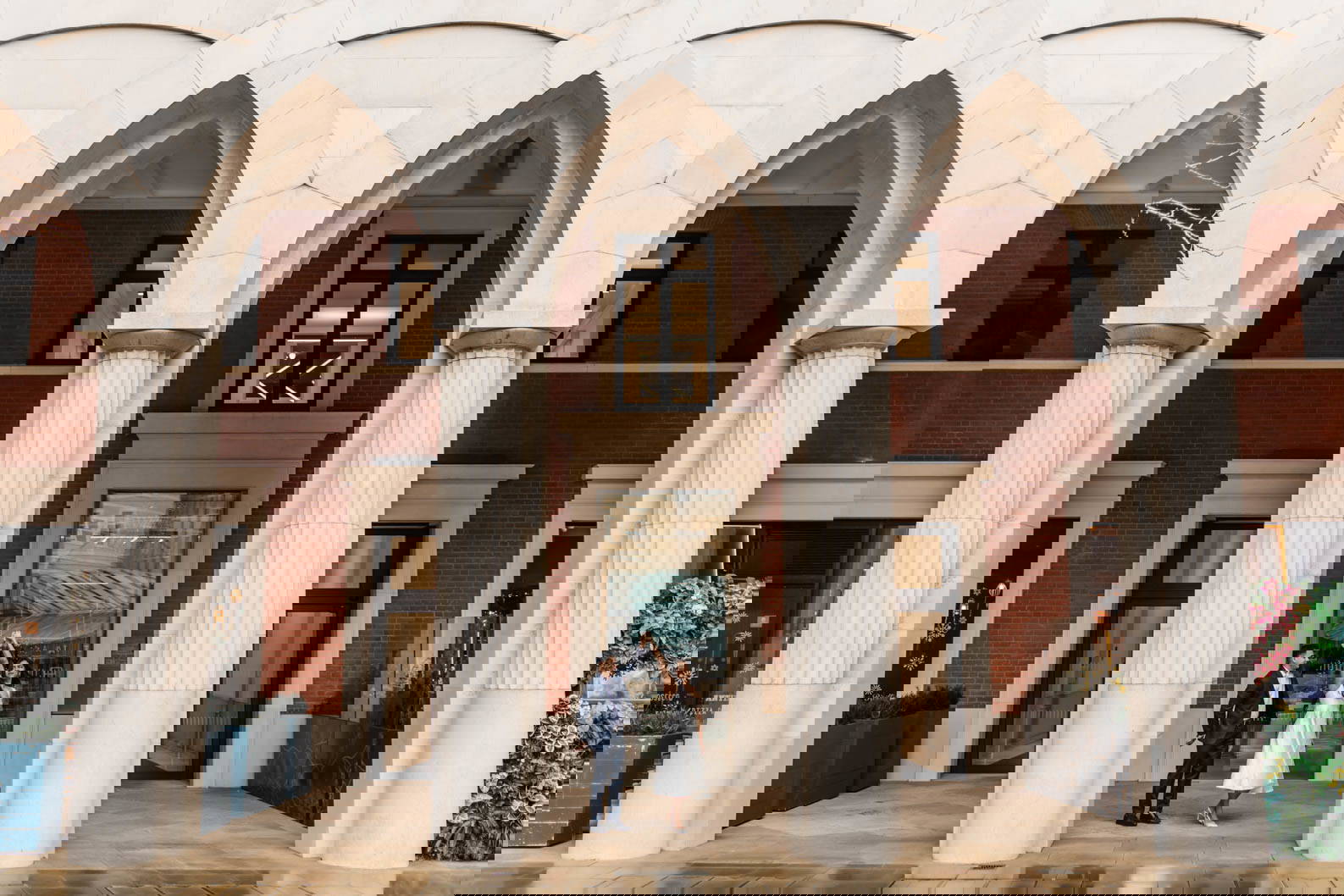 Engaged couple twirling in Brindleyplace archways