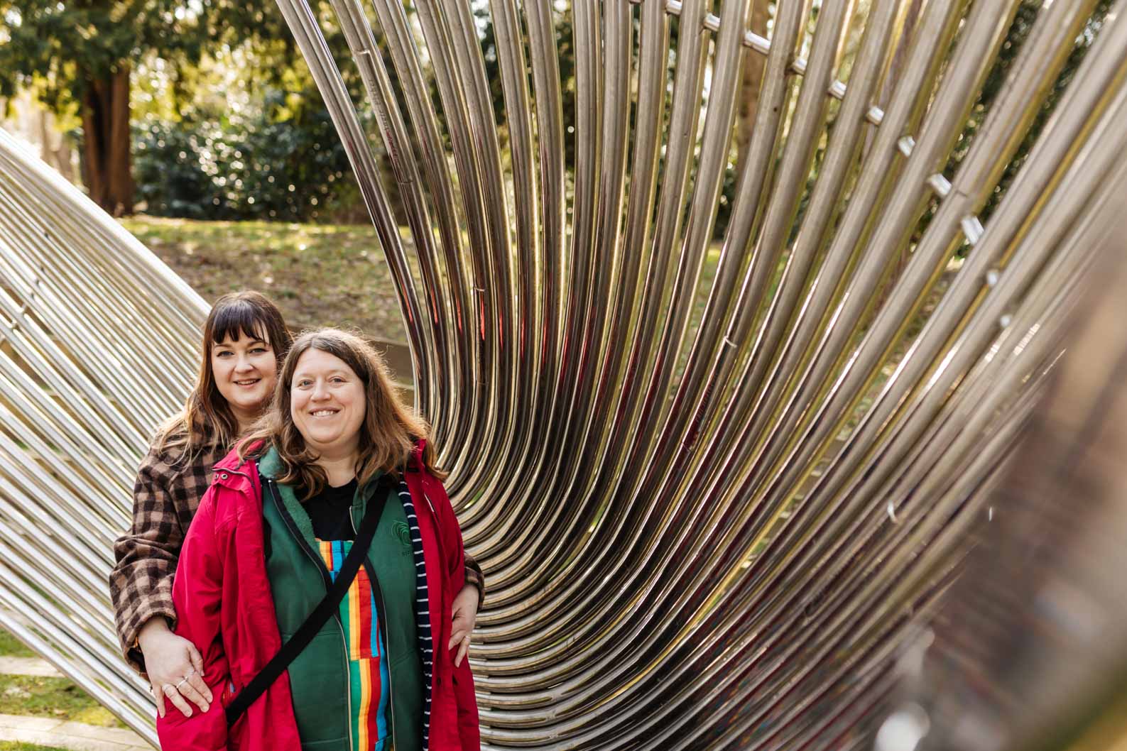 Couple smiling for a photo at Cannon Hill Park during a relaxed pre-wedding shoot.