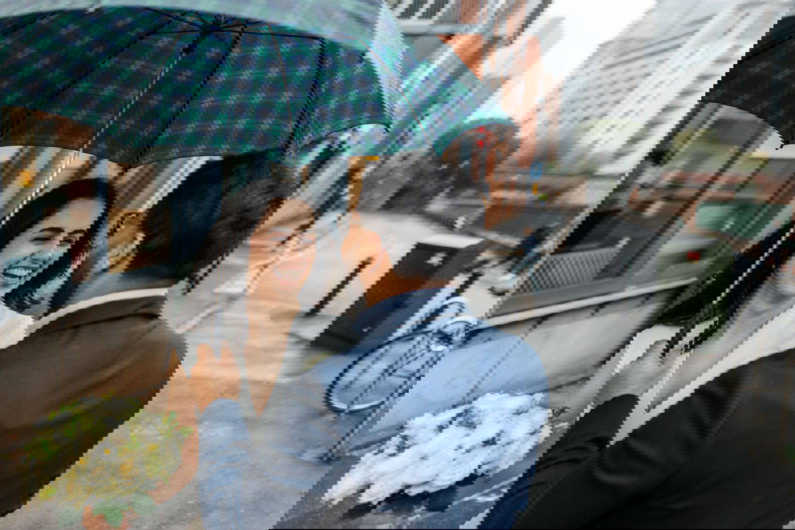 Rainy wedding photo, couple smiling after ceremony at Birmingham Register Office