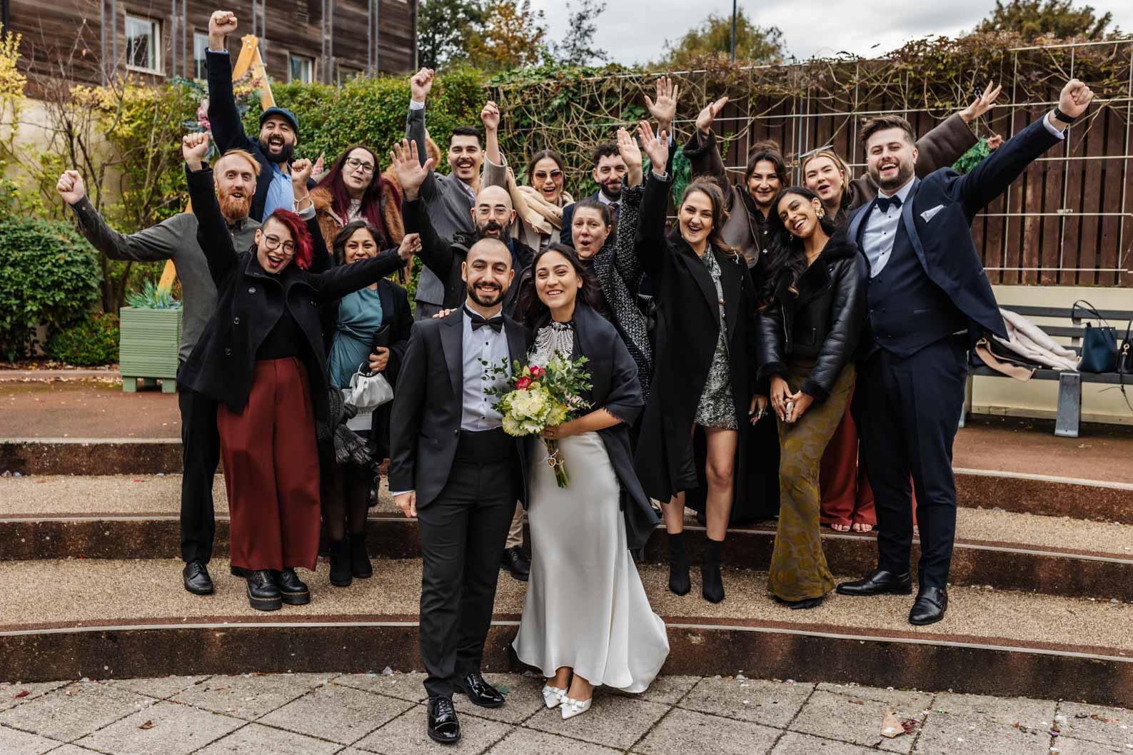 Friends posing for a group photo on the steps of Birmingham Register Office, perfect for micro wedding photography.