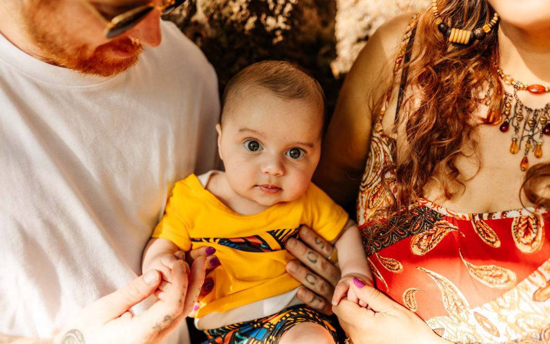 Parents cuddling their newborn baby during an at-home photoshoot in Birmingham